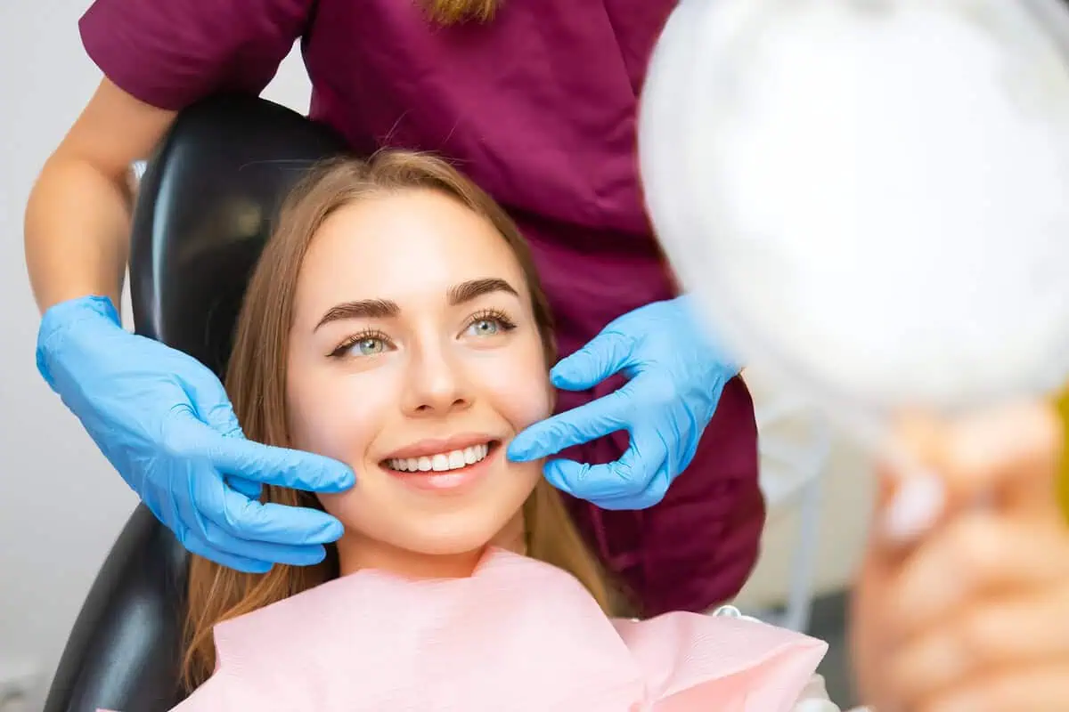Patient smiling as she sees her new smile
