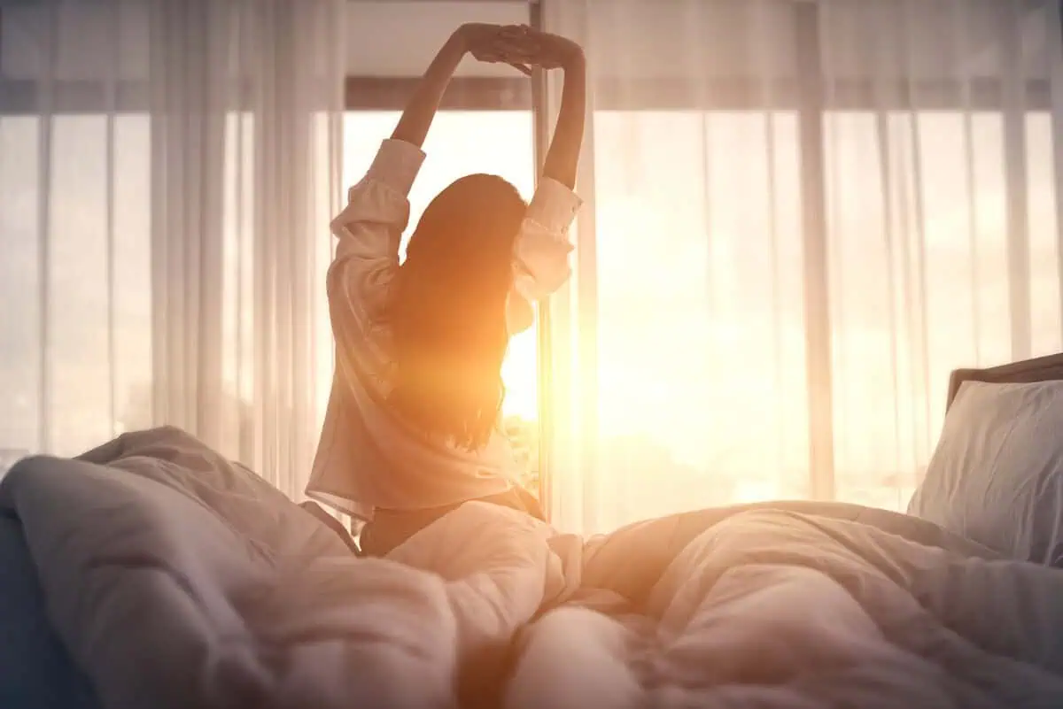 Rested adult waking up refreshed in the morning